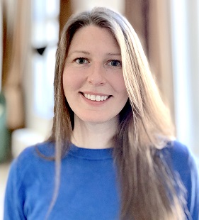 Jacqueline Sztepanacz in a blue shirt smiling at the camera